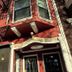 Twin Peaks Hotel in San Francisco exterior with red facade, fire escapes, and entrance