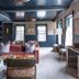 The Nantucket Hotel & Resort lounge with velvet seating, ornate cabinet, and windows in Nantucket
