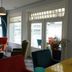 Villahotel Vlissingen lounge with colorful chairs and large windows overlooking Vlissingen