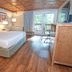 Carter Caves State Resort room in Olive Hill with king bed, wood floors and balcony view to trees
