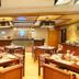 Senses Hotel Kolkata restaurant interior with wooden tables and bar counter