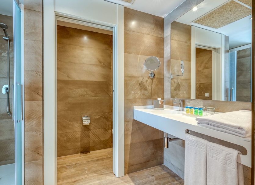Playamojácar in Mojacar bathroom with walk-in shower, double sink vanity and wood-look tile walls