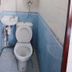 Garden Guest House bathroom in Hong Kong with a toilet and compact wall-mounted sink