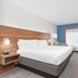 Holiday Inn Express & Suites Dallas - Grand Prairie I-20 guest room with king bed, desk and TV