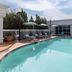 Hampton Inn ATL-Lawrenceville-I-85-Sugarloaf outdoor pool with lounge chairs and umbrellas in Lawrenceville