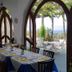 Hotel Parco Conte dining room with arched windows overlooking the sea in Casamicciola Terme