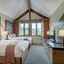 The Osprey at Beaver Creek guest room with two beds, vaulted ceiling and mountain-view windows