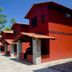 Pousada Villa Das Pedras in Pirenópolis, red lodge-style buildings along a stone walkway