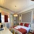 Triada Hotel Taksim in Istanbul guest room with ornate ceiling, red accents and double bed