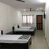 Vrp Guest House in Bhuj with simple twin beds and window curtains in a guest room