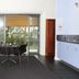 Bon Marie B&B in Hamilton room with dining table, TV, and sliding glass doors to balcony
