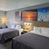 Bay Inn in Tawas City guest room with two beds and wall art above the headboard