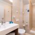 Concorde Old Bucharest Hotel bathroom with walk-in shower and wall-mounted sink in Bucharest