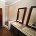 Bathroom at The Munday - B&B in Bedfordview with double sinks, mirrors, walk-in shower and bathtub