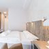 Osrodek Wypoczynkowy Wiga room in Kolobrzeg with a double bed, wall-mounted TV and seating area