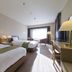 Akiu Resort Hotel Crescent in Sendai guest room with two beds, desk, TV and bright window