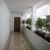 Suriwongse Hotel Bangkok hallway with potted plants and a wooden door