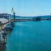 Marina Burgas Hotel in Burgas overlooking a blue harbor with cranes, docked ships and calm sea