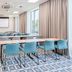 Hampton by Hilton Oswiecim meeting room with projector screen, tables and blue chairs in Oświęcim