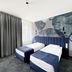 Szydlowski Gdansk guest room with two twin beds and floral mural wall