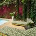 Hotel Barahona Cartagena poolside lounge chairs beside a small pool and lush tropical wall in Cartagena