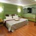 Left Bank Hotel Hsinchu City room with king bed, window seat, and pink recliner chair