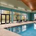 Holiday Inn Express & Suites Lexington Nw-The Vineyard indoor pool with large windows and lounge chairs