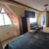 Hotel Savoy, La Paz guest room with bed, TV, seating area and bar-style table