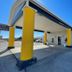 Kenedy Inn and Suites in Kenedy exterior with yellow columns and covered entrance