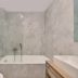 Mavrikos Hotel Tsilivi bathroom with bathtub, glass shower screen and toilet