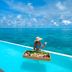 Diamonds Thudufushi Beach & Water Villas infinity pool with ocean view and breakfast tray
