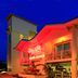Sunset Vistas Beachfront Suites in Treasure Island, lit exterior with balconies at dusk