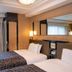 Apa Hotel Roppongi Ekimae Tokyo twin guest room with two beds, desk, and large window with curtains