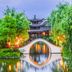 Hangzhou sailing International Hotel in Hangzhou with arched bridge over a reflective garden pond
