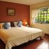 El Refugio Hotel & Spa in Sasaima: cozy guest room with king bed and large window with garden view