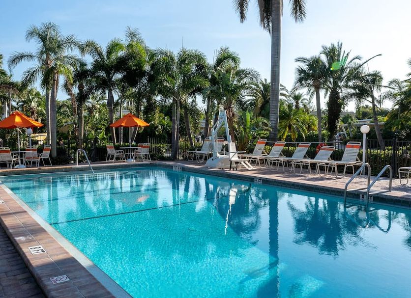 The Capri At Siesta in Sarasota: outdoor pool with lounge chairs and palm trees