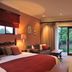 Claires of Sandton Luxury Guest House room in Sandton with king bed, sofa, desk and garden-view doors