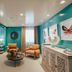 The Winston Solvang in Solvang: colorful guest room with bed, seating area, and butterfly wall art