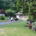 Rock Castle Resort in Lake George with cabins, a lawn, and guests near a driveway