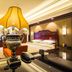 Wentou Oceanic Hotel Quanzhou guest room with ornate lamp, king bed and work desk