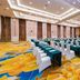 Haiqing Hotel Qingdao conference hall with rows of tables and chairs, colorful carpet and ceiling lights