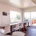 Haka House Taupo in Taupo meeting room with long table, chairs and sliding doors to terrace