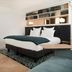 Hotel Louvre Montana in Paris guest room with king bed, bookshelf headboard, fireplace and lounge chairs