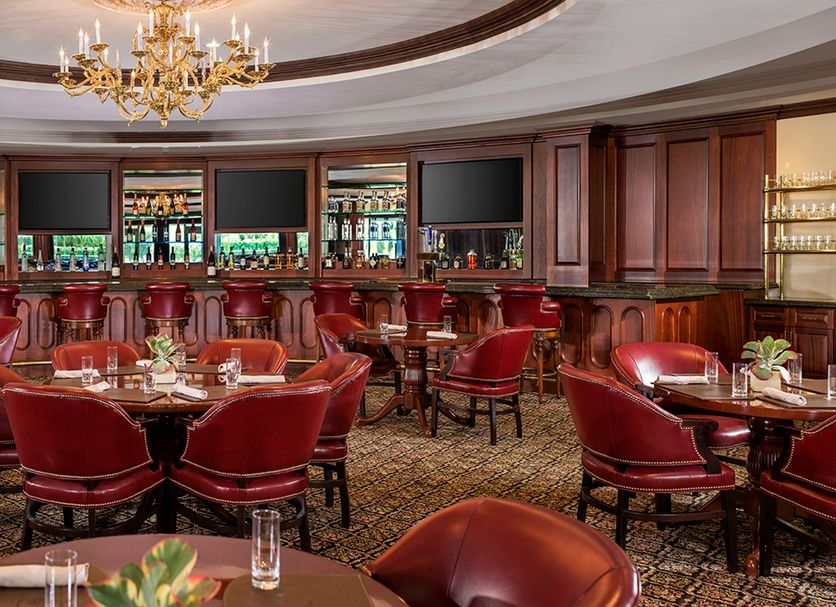Trump National Doral Miami in Doral: elegant restaurant with red leather chairs, round tables, and chandeliers