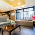 Oakhostel Zen Tokyo lobby with gray sofa, coffee table, and large windows