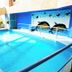 Golden Key Hotel Accra indoor pool with dolphin mural and lounge chairs