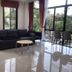 Radateeree Boutique Resort Chiang Mai lounge with sofa, chairs, round table, and garden views