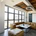 Wythe Hotel in Brooklyn loft-style lounge with large windows and leather sectional seating