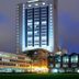 Boma Inn Nairobi in Nairobi at dusk, with a tall illuminated tower and low glass buildings