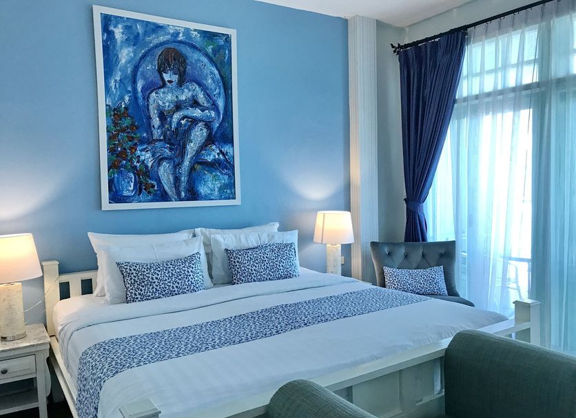 Casa Blanca Boutique Hotel Phuket City guest room with blue decor, bed, lamps and balcony doors